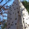 The top of a tall wooden climbing tower, featuring several footholds every couple feet.