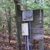 Electrical boxes at the Jack Pine tent site attached to a wooden sign that says "10500."