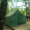 The front of a large green tent on a platform at the Jack Pine tent site.
