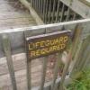A sign on a dock says, "Lifeguard Required."
